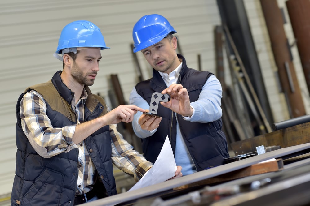 Engineer with mechanical worker checking on production-2