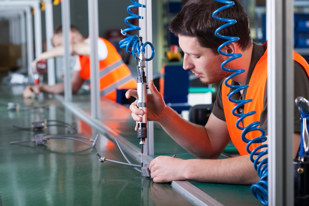 Men during precision work on production line, horizontal-2