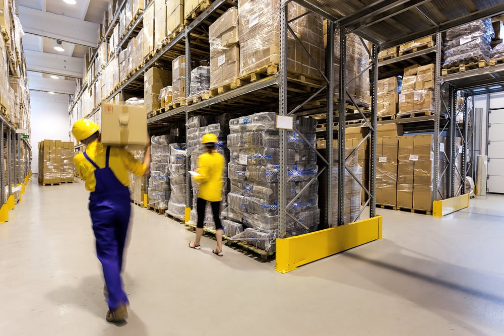 Warehouse worker with box and manager controlling products-1