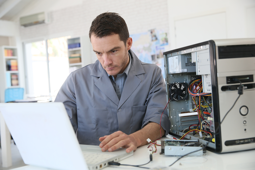 Technician fixing computer hardware